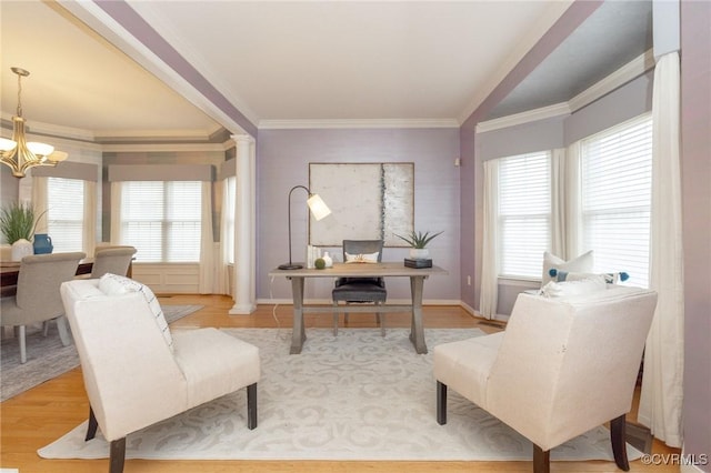 office space with light wood finished floors, a notable chandelier, crown molding, and baseboards