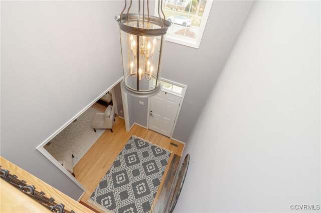 foyer featuring a notable chandelier and wood finished floors