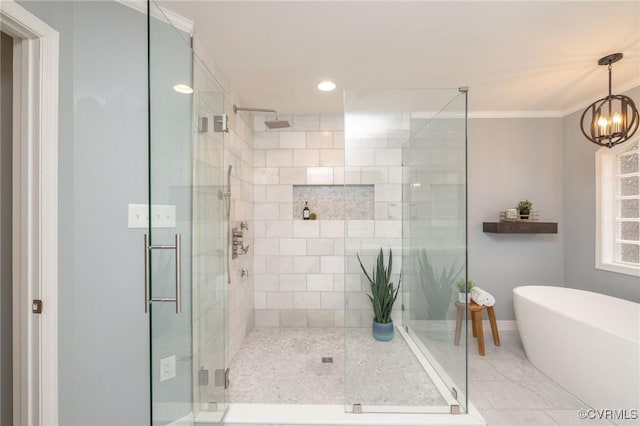 full bath with a shower stall, crown molding, baseboards, an inviting chandelier, and a soaking tub