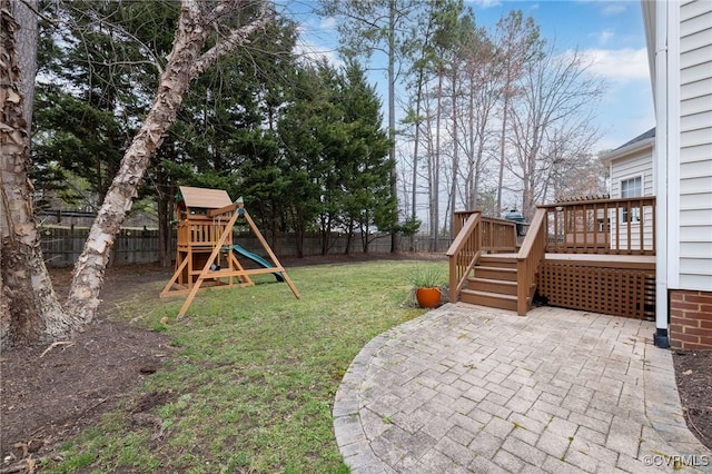 view of yard with a patio, a playground, a fenced backyard, and a wooden deck