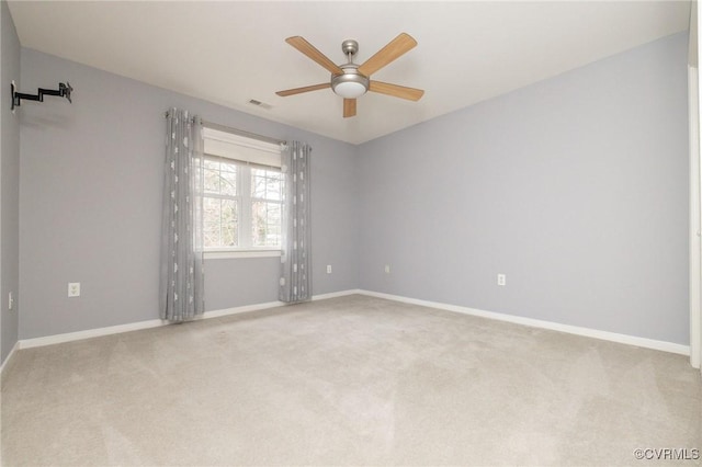 spare room featuring visible vents, baseboards, carpet, and ceiling fan