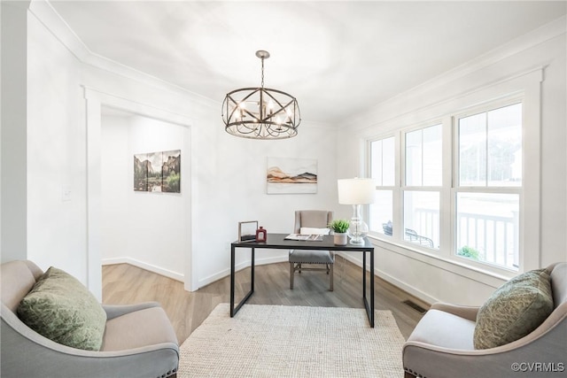 office area with visible vents, baseboards, a chandelier, ornamental molding, and wood finished floors