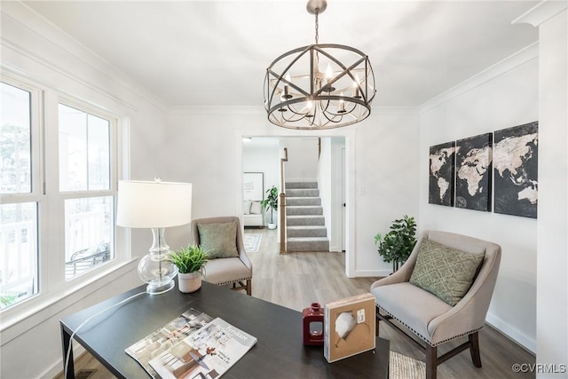 living area featuring crown molding, baseboards, stairway, wood finished floors, and a notable chandelier