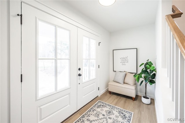 entrance foyer with light wood-type flooring and baseboards