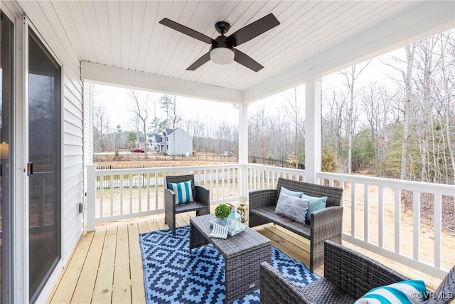 deck with outdoor lounge area and ceiling fan