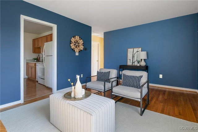 living area featuring wood finished floors and baseboards