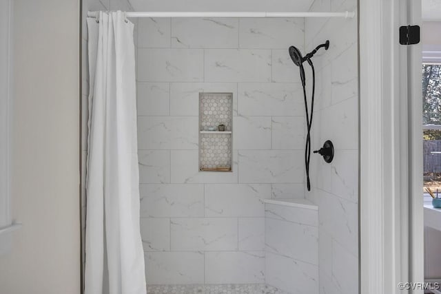 interior details with a tile shower