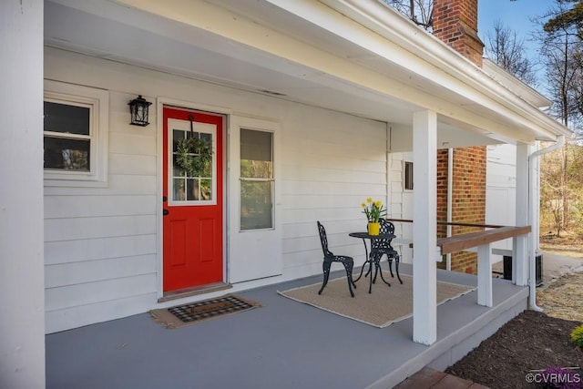 property entrance with a porch and a chimney