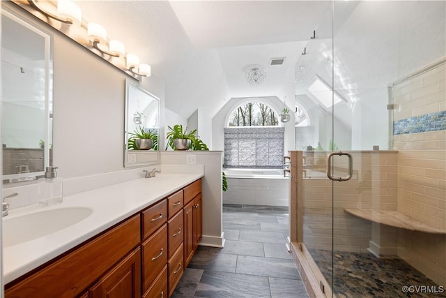 bathroom with a sink, a shower stall, double vanity, a bath, and vaulted ceiling