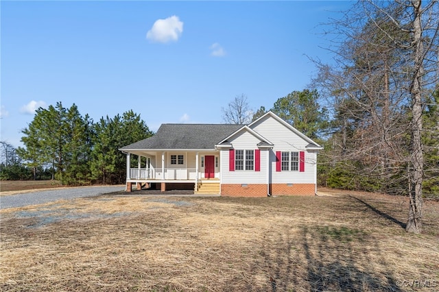 view of front facade featuring a shingled roof, covered porch, driveway, and crawl space