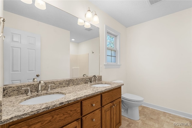 bathroom with a sink, visible vents, baseboards, and toilet