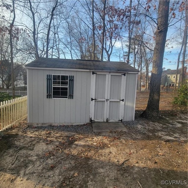 view of shed with fence