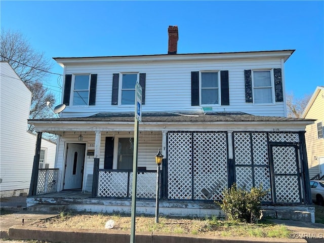 view of front of house featuring a porch and a chimney