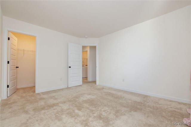 8160 Lyman Ct, Mechanicsville, VA 23116 - unfurnished bedroom with light carpet, a spacious closet, and washer / dryer