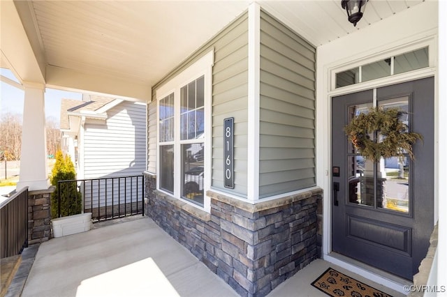 8160 Lyman Ct, Mechanicsville, VA 23116 - doorway to property featuring covered porch and stone siding