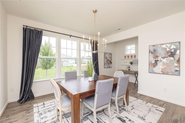 8160 Lyman Ct, Mechanicsville, VA 23116 - dining room with a chandelier and light wood-style floors