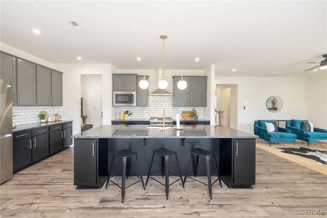 8160 Lyman Ct, Mechanicsville, VA 23116 - kitchen with light wood-style flooring, tasteful backsplash, stone countertops, and recessed lighting
