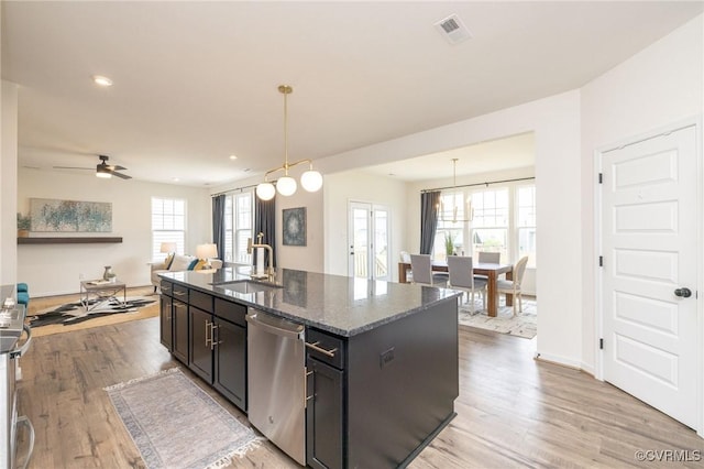 8160 Lyman Ct, Mechanicsville, VA 23116 - kitchen featuring stainless steel appliances, light wood-style flooring, open floor plan, dark stone countertops, and recessed lighting