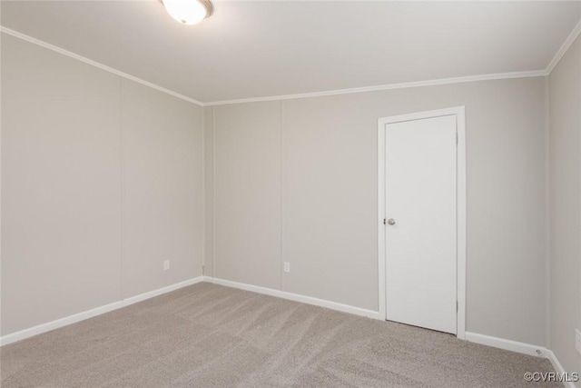 unfurnished room with light colored carpet, crown molding, and baseboards