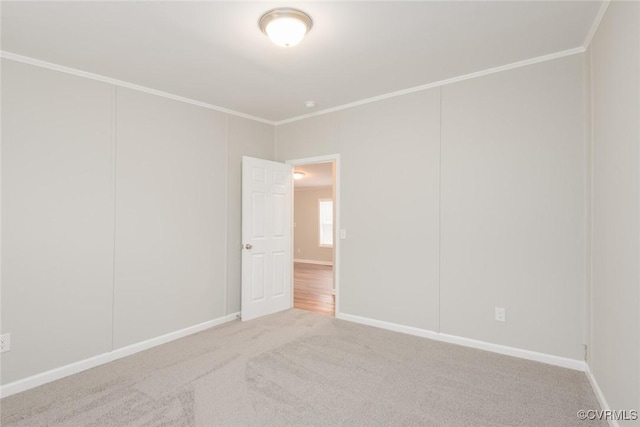 empty room with baseboards, carpet floors, and ornamental molding