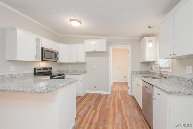 kitchen featuring light stone countertops, light wood-type flooring, a peninsula, stainless steel appliances, and a sink