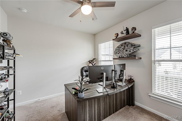 home office with carpet flooring, a ceiling fan, and baseboards