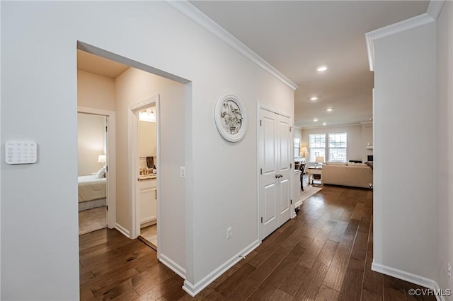 corridor with recessed lighting, baseboards, dark wood-type flooring, and crown molding