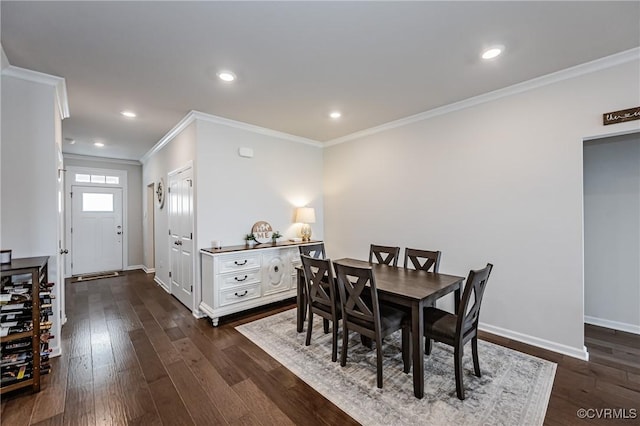 dining area featuring dark wood-style floors, baseboards, and ornamental molding