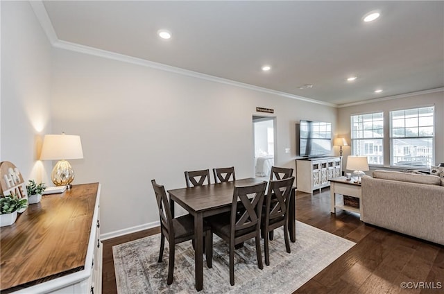 dining room featuring dark wood-style floors, recessed lighting, crown molding, and baseboards