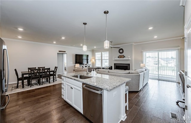 kitchen with a sink, dishwasher, dark wood finished floors, and ornamental molding