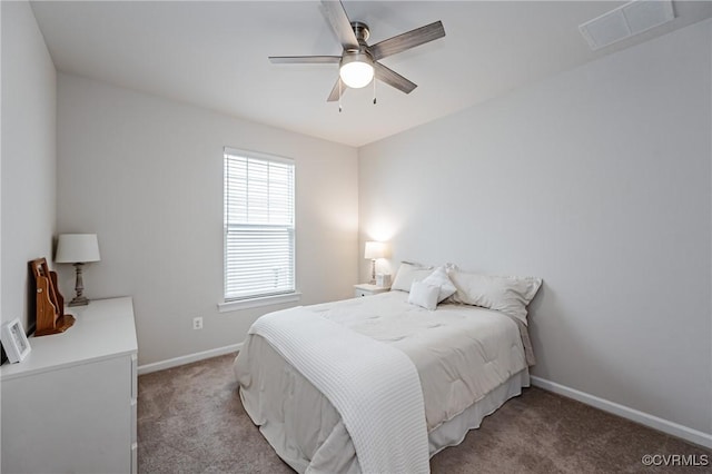 carpeted bedroom with visible vents, baseboards, and ceiling fan