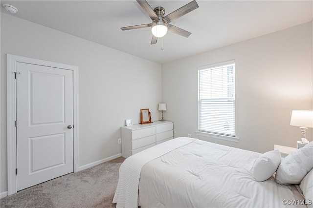 carpeted bedroom featuring baseboards and ceiling fan