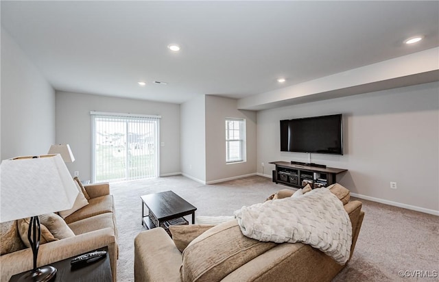 living room featuring recessed lighting, baseboards, and light colored carpet