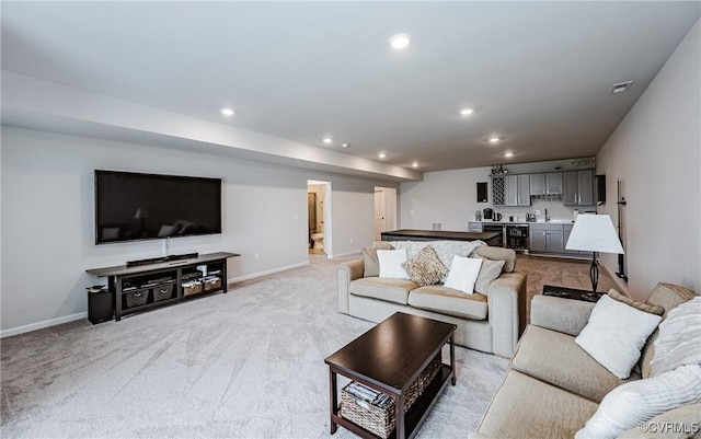 living area with visible vents, recessed lighting, light colored carpet, and baseboards