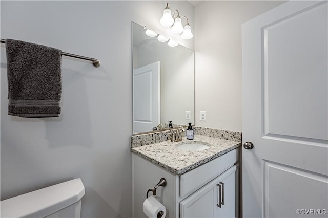 bathroom featuring toilet and vanity