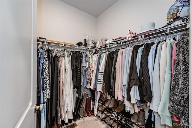 walk in closet with visible vents and carpet