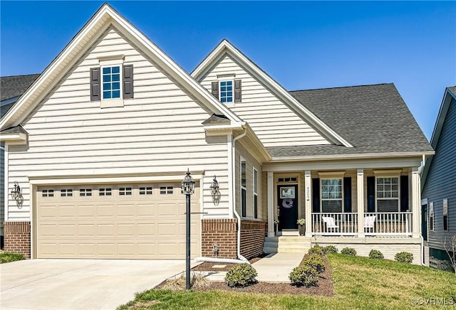 traditional-style home with brick siding, covered porch, concrete driveway, and a shingled roof