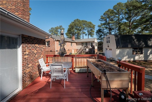 wooden terrace with an outbuilding