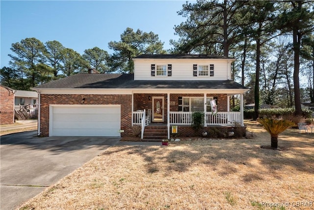 traditional home featuring brick siding, covered porch, an attached garage, and concrete driveway