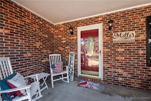 entrance to property featuring brick siding