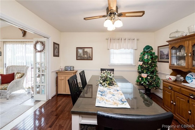 dining space with ceiling fan and dark wood-style flooring