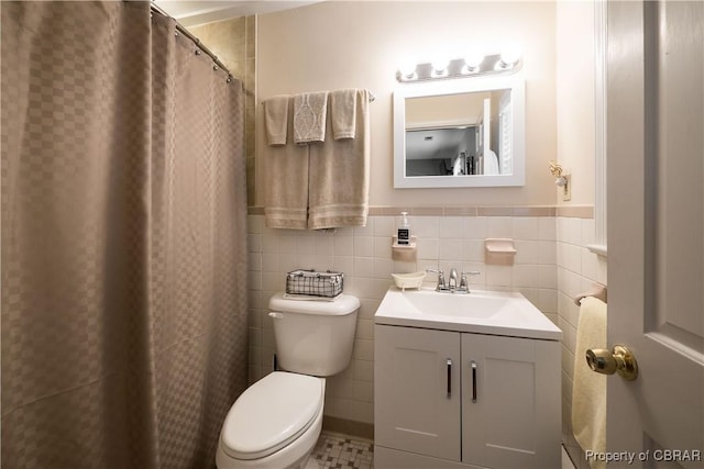 full bathroom featuring vanity, tile walls, and toilet