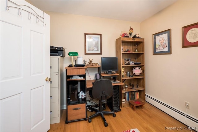 office with a baseboard heating unit and wood finished floors