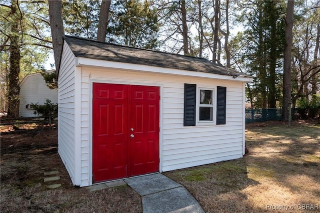 view of outbuilding with an outbuilding and fence