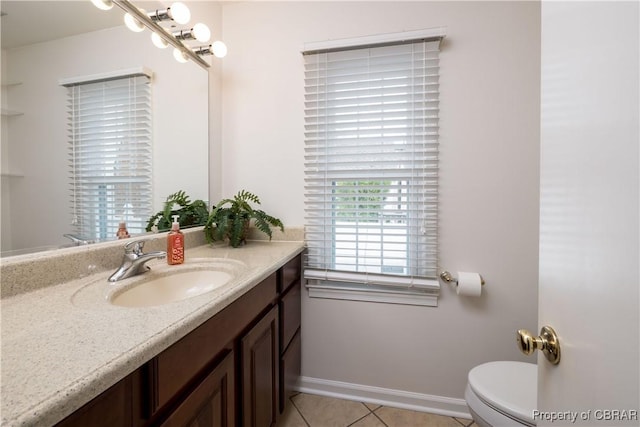 bathroom with tile patterned floors, baseboards, toilet, and vanity