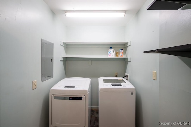 washroom featuring electric panel, laundry area, and washer and dryer