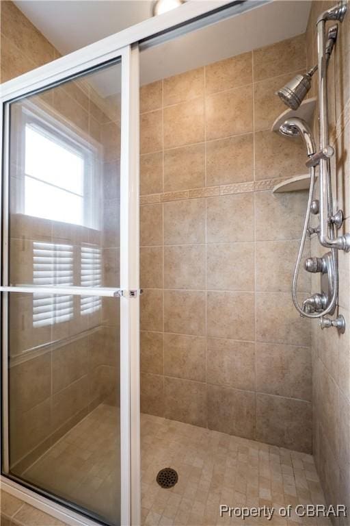 bathroom featuring a shower stall