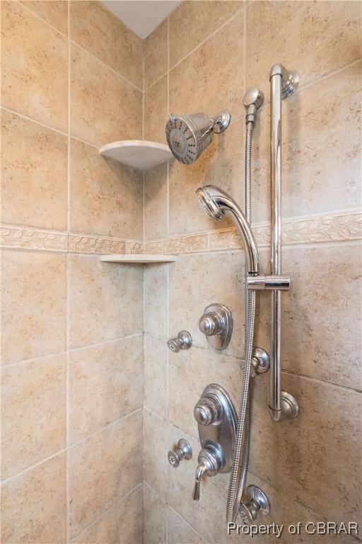 interior details with a tile shower