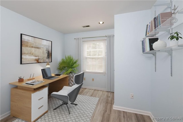 office space featuring recessed lighting, light wood-type flooring, baseboards, and visible vents