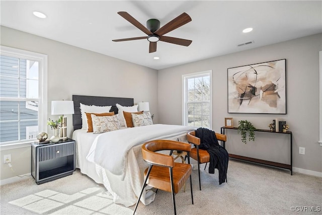 bedroom with light carpet, visible vents, recessed lighting, and baseboards